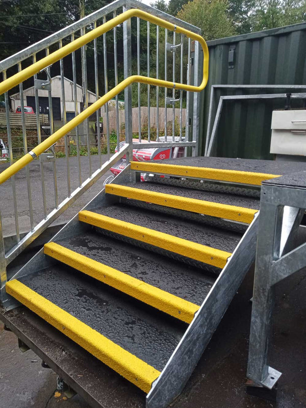 Anti-slip GRP stair tread cover with high-grip gritted fibreglass surface fitted to a step