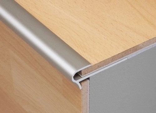 Aluminium stair nosing being fitted to a step edge