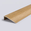 Oak wood effect aluminium door threshold ramp profile shown on a plain studio background