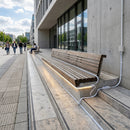 Modern concrete steps with LED strip lighting and extension cables connecting illuminated stair nosings in urban plaza