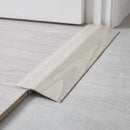 Arctic Oak wood effect threshold ramp fitted in a doorway bridging laminate and vinyl flooring