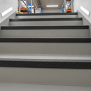 Black GRP stair nosing on industrial concrete stairs — permanent corrosion-proof anti-slip protection