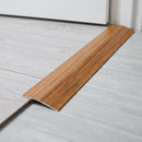 Chestnut wood effect threshold ramp fitted in a doorway bridging laminate and vinyl flooring