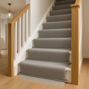 Satin nickel stair rods on new-build UK home staircase with dove grey plush runner