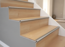 Silver aluminium laminate stair nosing for 14mm flooring installed on oak laminate UK staircase - looking up multiple steps