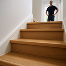 Renovated UK staircase with new wood effect uPVC stair nosings fitted to each step - professional laminate stair renovation