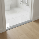 PVC floor transition strip at bathroom doorway between ceramic tile and laminate