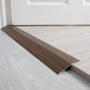 Japanese Chestnut wood effect threshold ramp fitted in a doorway bridging laminate and vinyl flooring