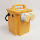 Portable 110V 3.3kVA site transformer in a yellow steel case with a tubular carry handle, black mains lead and two 110V outlets with hinged yellow weatherproof flaps, on a plain studio background