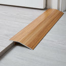 Hickory wood effect threshold ramp fitted in a doorway bridging laminate and vinyl flooring