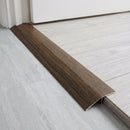 Congo Wenge wood effect threshold ramp fitted in a doorway bridging laminate and vinyl flooring