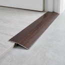 African Ebony wood effect threshold ramp fitted in a doorway bridging laminate and vinyl flooring