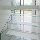 Transparent anti-slip tape on glass or polished stone stairs — invisible safety grip