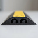 Cut cross section of the low profile two channel rubber cable cover showing both enclosed channels side by side, each holding a cable