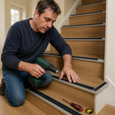 Homeowner installing 46mm aluminium stair nosing on laminate UK home staircase - DIY screw fix installation