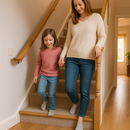 Family using UK home staircase with wood effect uPVC stair nosings installed - oak effect step edge protection