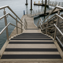 Black GRP stair nosing on marine dock or coastal stairs — corrosion-proof saltwater resistant
