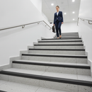 Heavy duty 65mm aluminium stair nosing on commercial UK tiled staircase - wide ribbed anti-slip profile