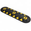 Assembled black rubber speed bump with yellow reflective triangles, fixing bolt holes and rounded end caps, on a white background