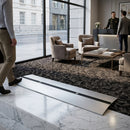 Adjustable aluminium floor ramp in matt silver finish, extending from 0.9m to 2.8m for indoor and outdoor use