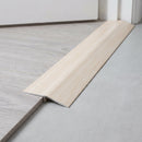 White Pine wood effect threshold ramp fitted in a doorway bridging laminate and vinyl flooring