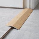Sandy Oak wood effect threshold ramp fitted in a doorway bridging laminate and vinyl flooring