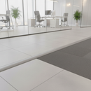 Grey PVC floor transition strip in modern UK office between tiles and carpet
