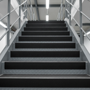Black GRP stair tread covers on industrial access stairs — full tread surface coverage heavy duty