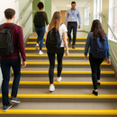 Yellow GRP anti-slip nosing on school staircase providing DDA-compliant step edge visibility