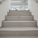 Aluminium tile-in step edging on commercial ceramic stairs in UK office building - professional step edge trim