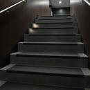 Black GRP stair tread covers on contemporary commercial building stairs — discreet professional finish