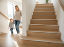 Laminate stair nosing push-in aluminium installed on modern UK oak laminate staircase - woman and child descending safely