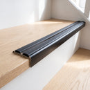 Black anodised 36mm slim aluminium stair nosing with twin black rubber inserts fitted to a light oak stair tread