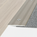 Close-up detail of anodised aluminium flat threshold strip showing flush installation between laminate and carpet - screw-fix profile