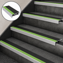 Black and green slimline nosings on four dark grey steps, with an inset close-up of the profile