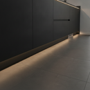 Black vinyl skirting trim at base of dark kitchen units