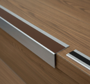 Close-up of DDA anti-slip aluminium stair nosing 70mm wide showing permanently bonded PVC insert at step nose edge