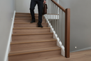 uPVC wood effect stair nosing in Walnut — real-life installation on UK staircase with person using the stairs