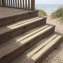 Buff 50mm fine grit GRP anti-slip strips on timber steps down to a beach from a seaside cottage