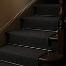 Pewter stair rods on charcoal grey runner carpet — sophisticated British home staircase