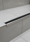 Retro-fit stainless steel stair nosing R11 Black RAL 9011 anti-slip tread TREP-GK on tiled stairs UK