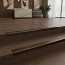 Bronze NAS stair nosing on dark walnut LVT stairs in premium commercial office reception UK