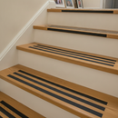Narrow 19mm anti-slip strips on stair nosing edges in UK home — targeted step edge grip