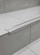 Retro-fit stainless steel stair nosing R11 Transparent tread TREP-GK bonded to existing tiled steps
