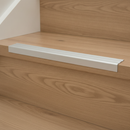 NAS aluminium self-adhesive stair nosing installed on oak laminate staircase in modern UK home
