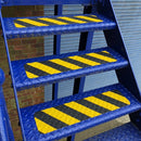 Black/yellow conformable anti-slip tread applied to metal step with raised surface pattern