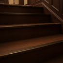 Bronze finish NAS aluminium stair nosing on traditional dark wood staircase in period UK home