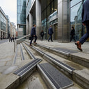 Commercial GRP stair nosing with non-slip surface installed on concrete steps in urban business district