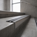 Raked back carborundum nosing with graphite grey grit insert