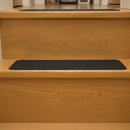 Black self-adhesive anti-slip stair tread 150x610mm installed on wooden domestic step